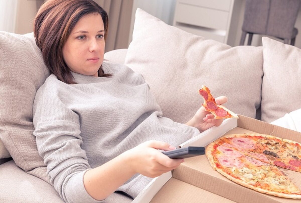 woman munching on pizza